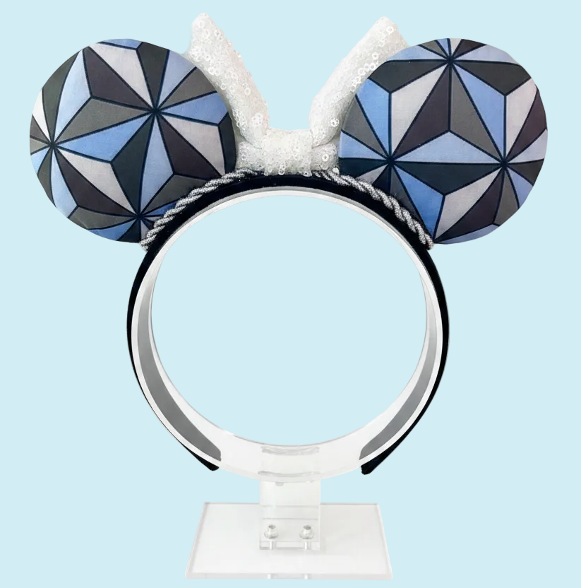 Handmade and ready to ship Mouse ear headband with a geometric design inspired by Spaceship Earth ride and a white iridescent bow on a universal sized black headband.