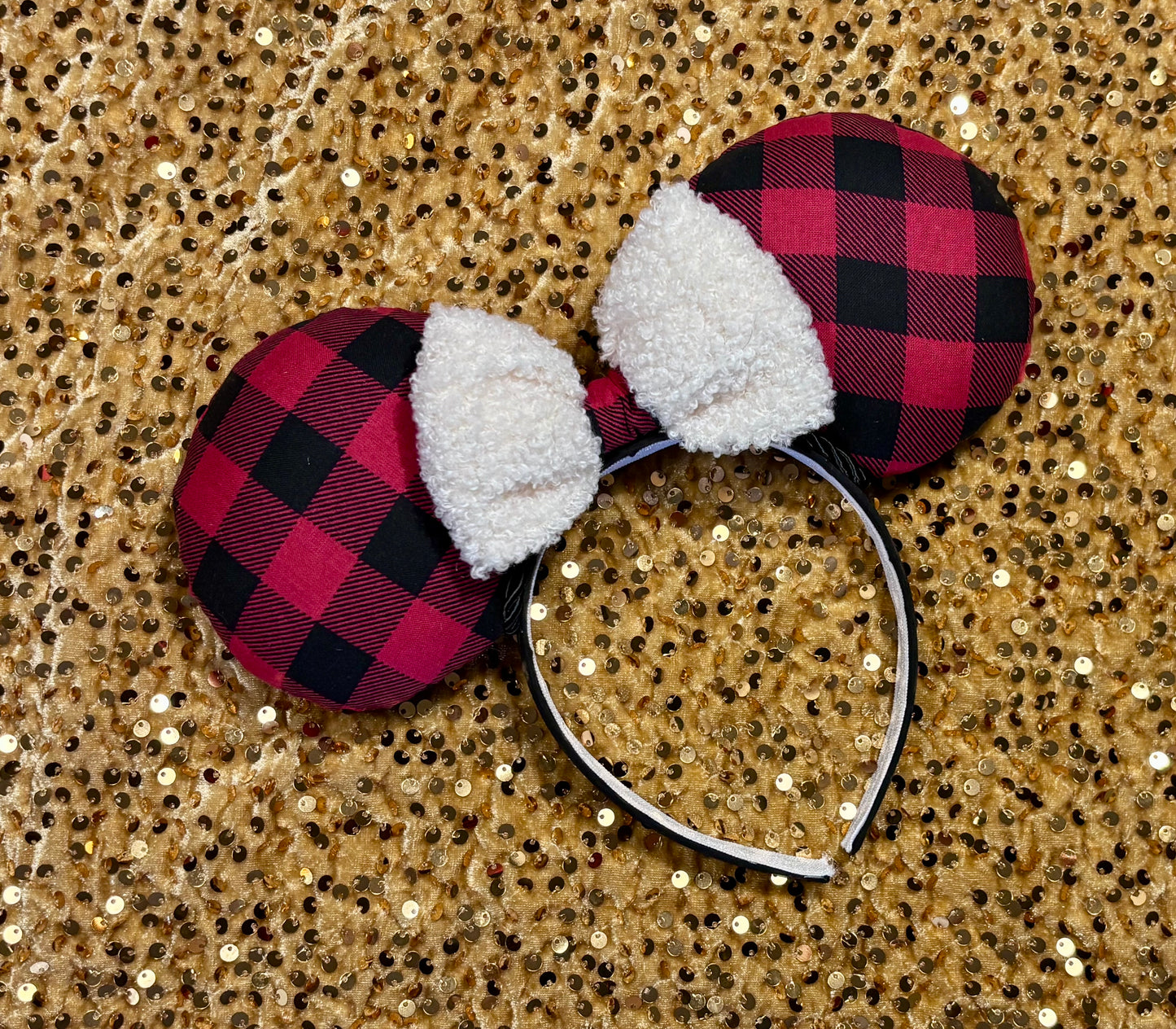 Buffalo Plaid mouse ears on a glittery gold background
