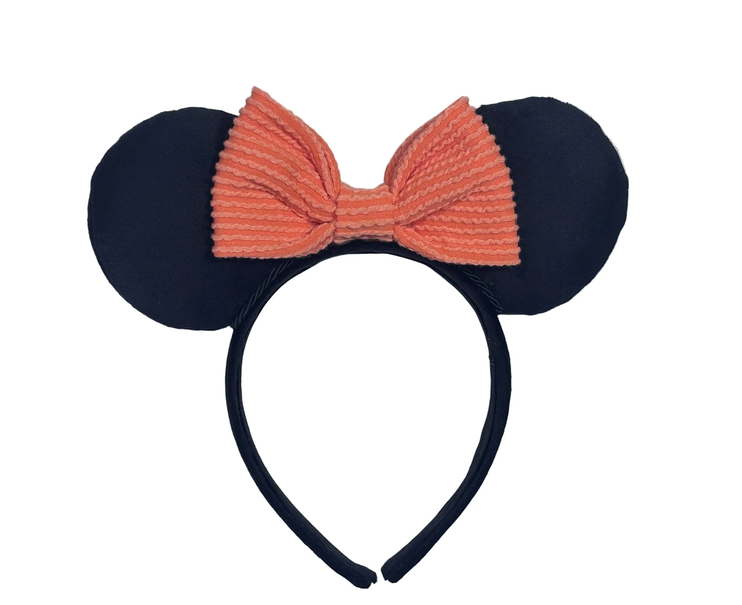 Velvet black mouse ears with a pink bow on a textured gray background