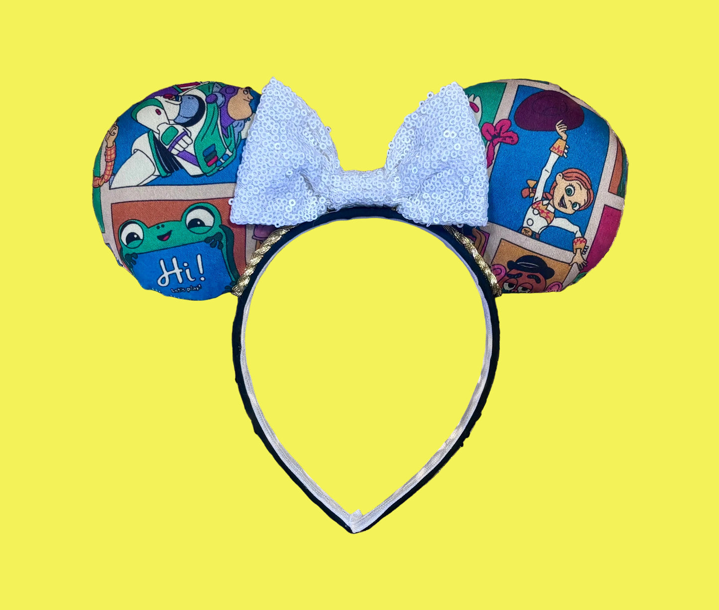 Handmade and ready to ship TS5 Inspired mouse ears. The character fabric is on the front and the back. On a universal sized black poly fabric headband. With a white sequin bow.