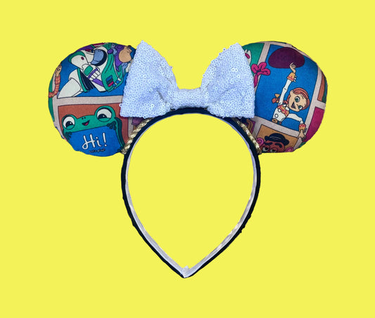 Handmade and ready to ship TS5 Inspired mouse ears. The character fabric is on the front and the back. On a universal sized black poly fabric headband. With a white sequin bow.