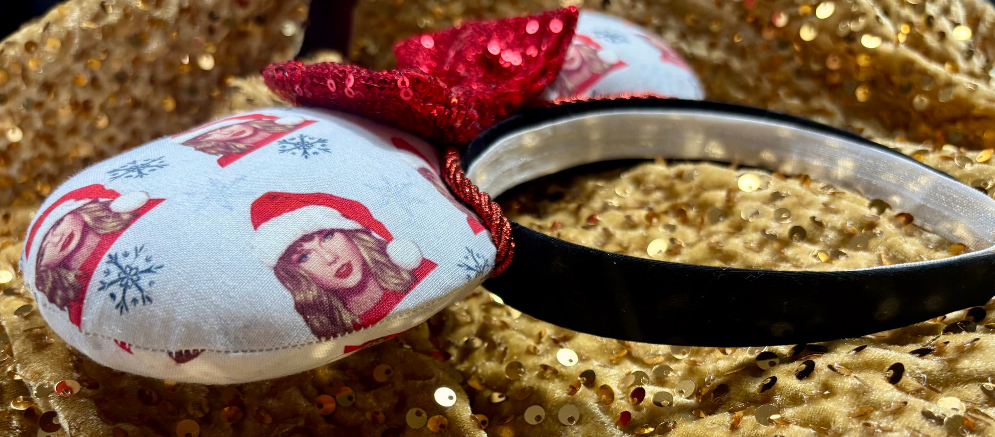 Mouse ear headband with red bow and character print on a glittery background