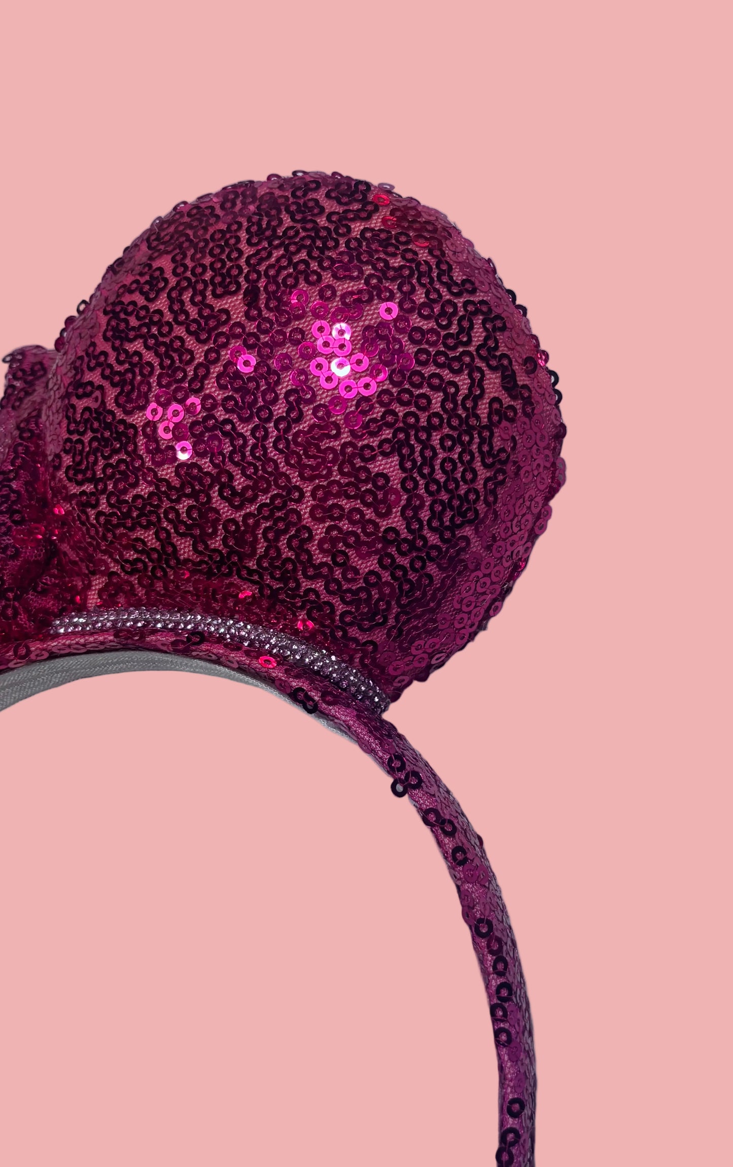 Handmade and ready to ship, Hot Pink Custom Ears. Fabric is on ears front and back with pink rhinestone trim along the inner ears and a matching hot pink sequin bow. The Headband is universal sized and has the same hot pink sequin fabric.