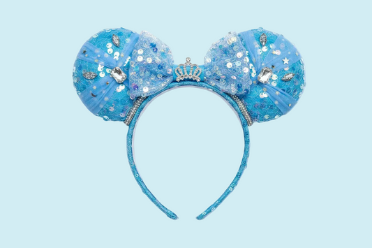 Handmade and ready to ship blue sequin mouse ears headband inspired by Cinderella with tulle and silver gemstones with a crown charm middle and rhinestone trim along inner ears.