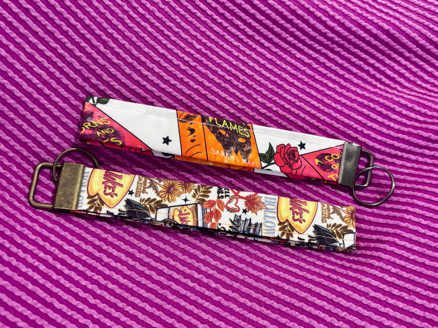 Keychain with colorful design on a purple striped background