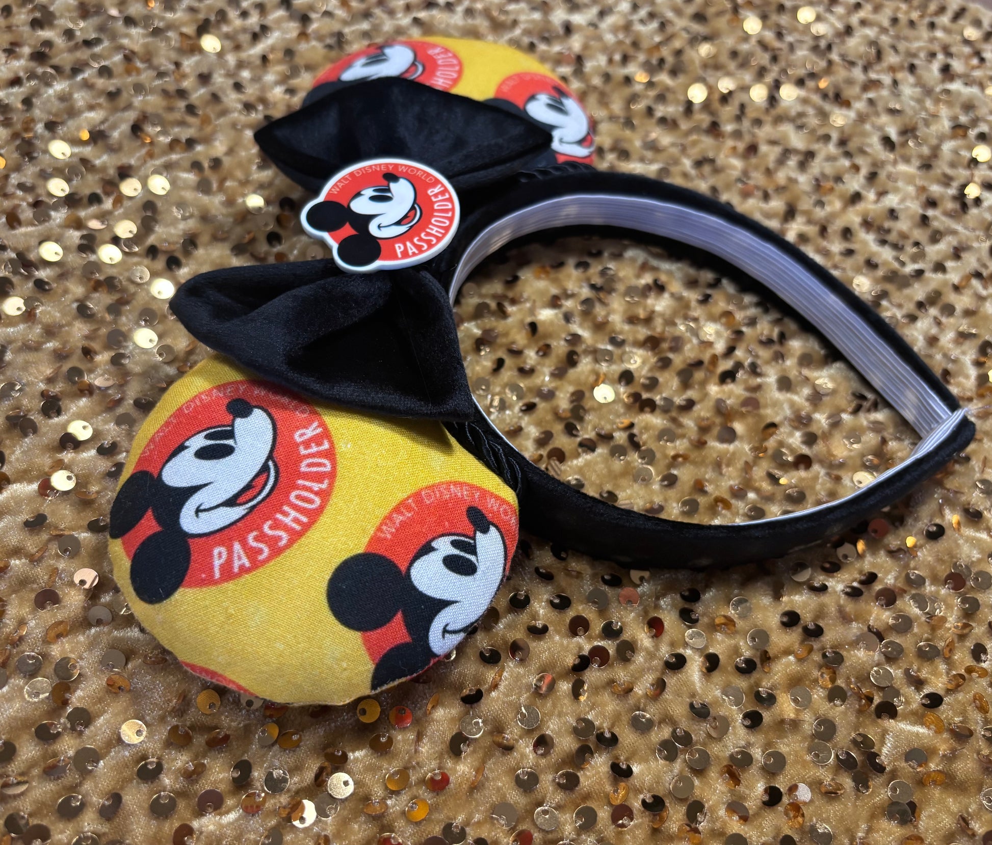 Mouse ears with AP design on a glittery gold background