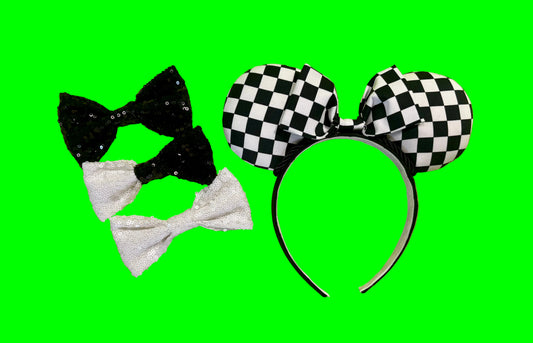 Black and white checkered bow headband with black and white sequin bow as options for the headband on a green background