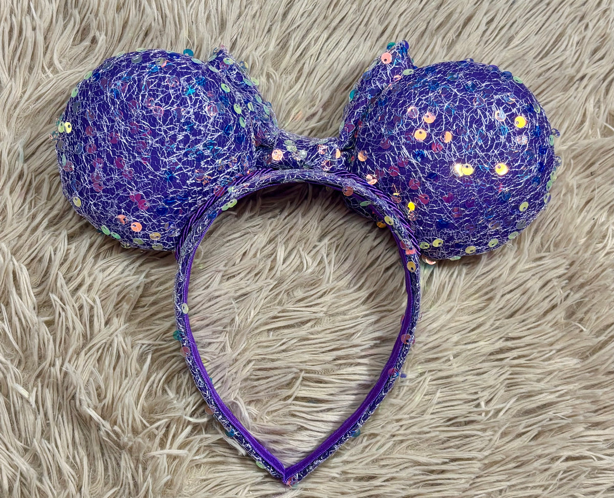 The back side view of purple iridescent sequins ears.