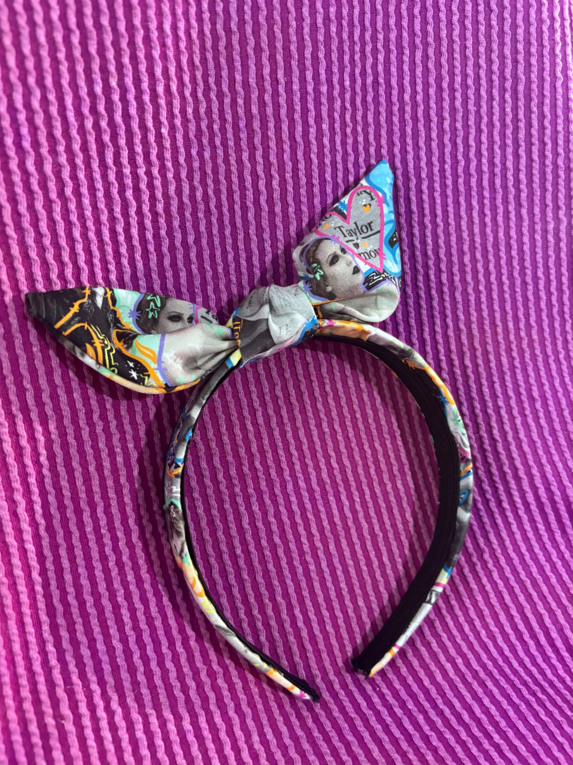 Decorative headband with a bow on a purple textured background