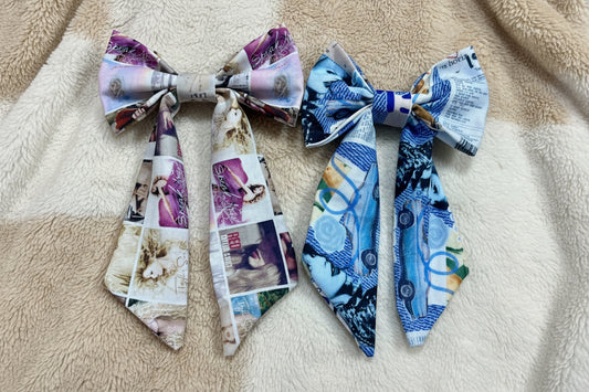 Two decorative Swiftie bows made on a glittery gold background