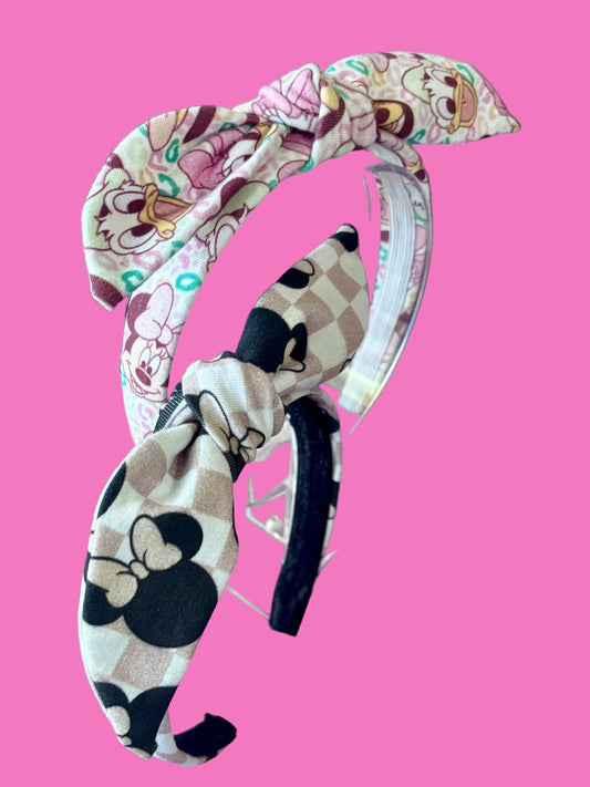 Handmade and ready to ship 2 pack bundle of twisted bow headbands. One in Checkered Minnie and one in Leopard friends. made with stretchy Cotton Lycra fabric and on a universal sized headband lined with elastic.