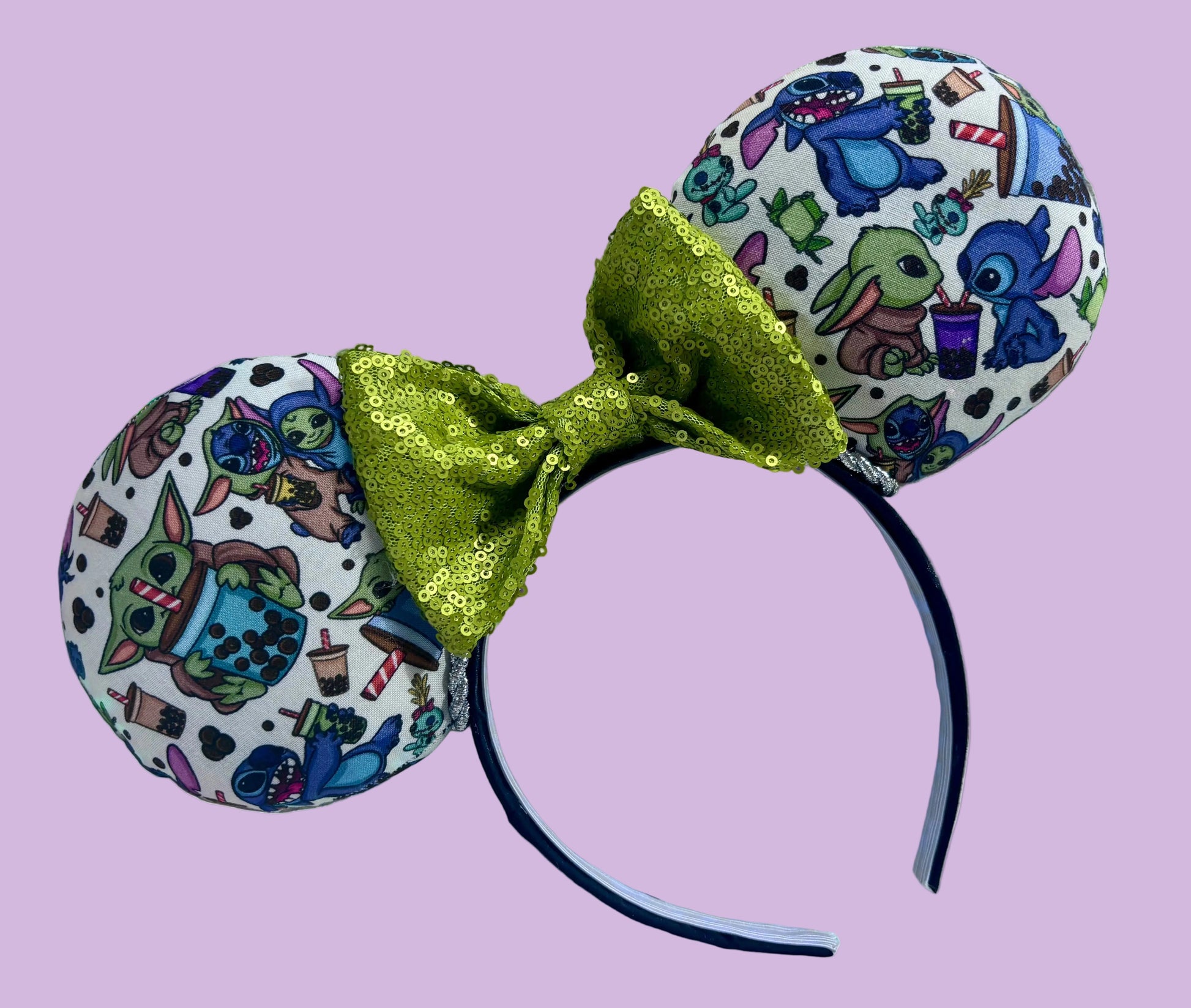Handmade and ready to ship. Stitch and Baby Yoda are drinking coffee on the front and back with a lime green sequin bow. 