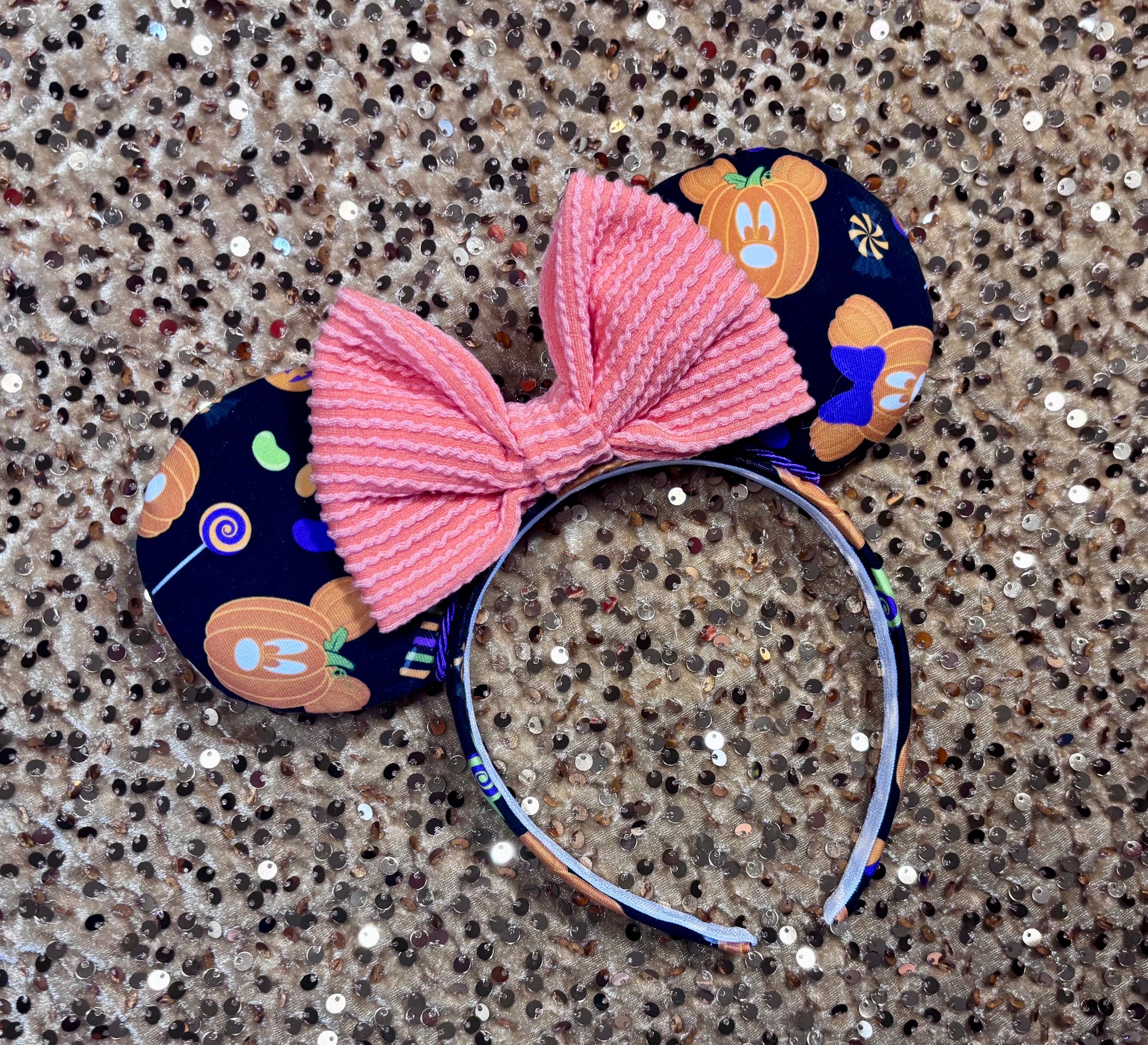 handmade mouse ears with halloween boo to you fabric on ears and the headband.  Orange waffle print bow