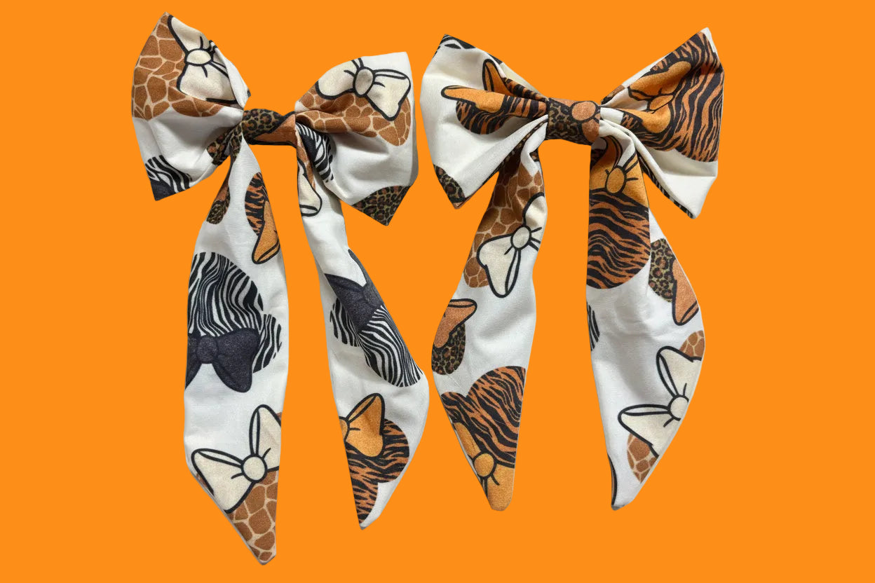 Two handmade and ready to ship fabric bows with animal print patterns in French Tailed Bows with barrette backings. 