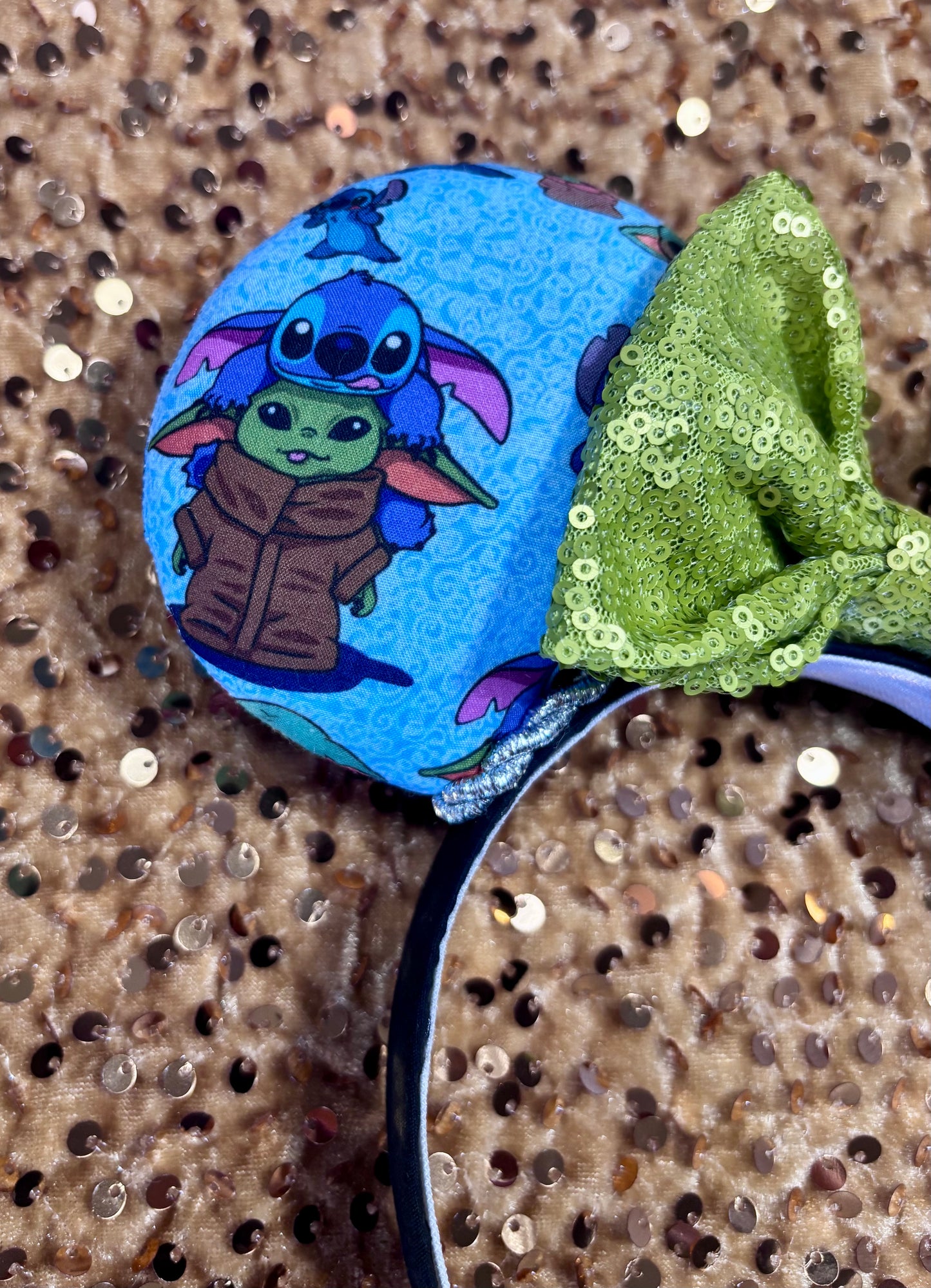 Handmade and ready to ship small friend aka Stitch and Baby Yoda Mouse ears with a lime green sequin bow. Of course, you can request any bow in sequin if you prefer and I will attach it. Shown on a gold sequin background.