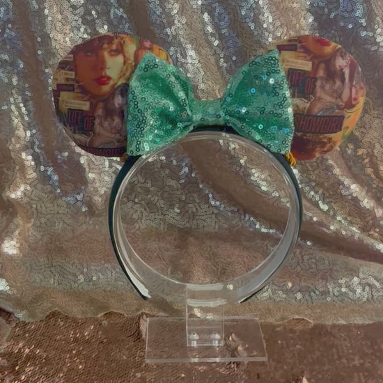 Handmade and ready to ship Showgirl Collage Mouse ears with the fabric on the ears, front and back and a mint sequin bow. The headband is a universal sized headband and has black poly cotton fabric on it.