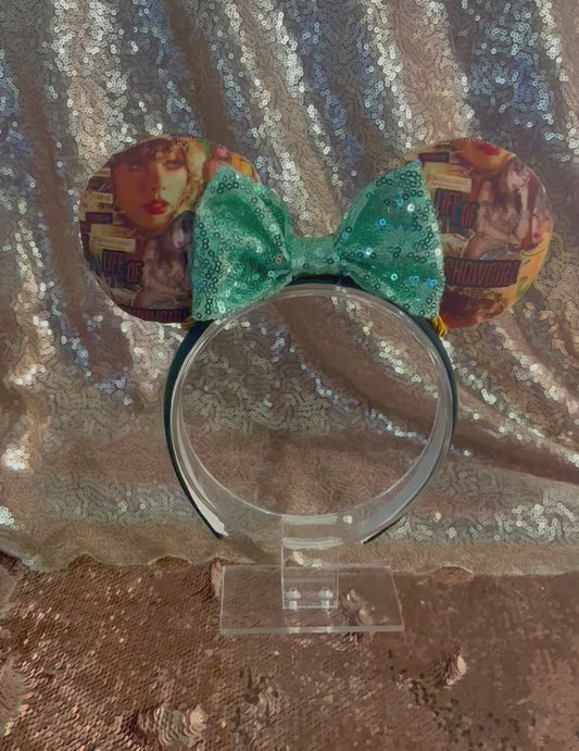 Handmade and ready to ship Showgirl Collage Mouse ears with the fabric on the ears, front and back and a mint sequin bow. The headband is a universal sized headband and has black poly cotton fabric on it.