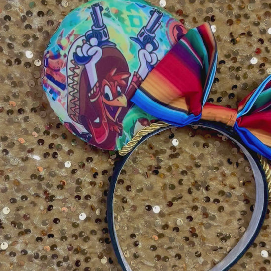 Colorful Handmade and ready to ship mouse ears with a colorful bow on an orange background with duck cartoon images on the ears front and back with Handmade and ready to ship. yellow twisted trim and on a black poly universal sized headband