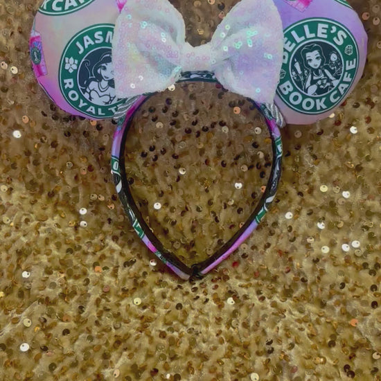 Handmade and ready to ship custom ears with popular coffee themed with princesses on fabric. White iridescent bow and silver twisted trim on a universal sized headband with matching design as the mouse ears.
