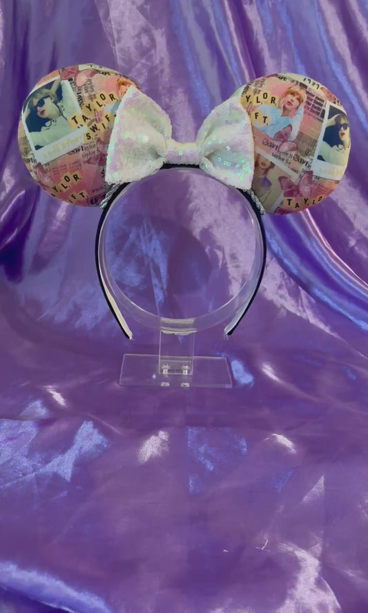 Handmade and ready to ship Taylor Inspired mouse ears. The character fabric is on the front and the back. On a universal sized black poly fabric headband. With a white iridescent sequin bow.