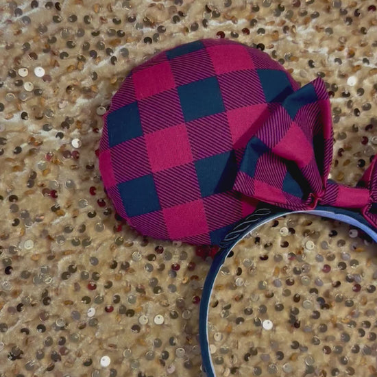 Handmade and ready to ship Buffalo Plaid mouse ears on both the front and back. On a black headband that is universal sized. The set shows a matching buffalo plaid bow. Item is shown on a gold sequin background.