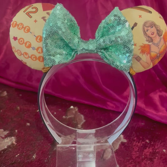 Handmade and ready to ship Ophelia Mouse ears with TS images on the ears along with TLOAS with a mint sequin bow, orange twisted trim and on a black universal sized headband. 