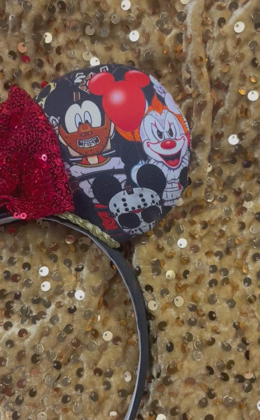 Handmade and ready to ship Halloween Horror Toons Mouse ears with the fabric is on the ears, front and back and a red sequin print bow and gold twisted trim. The headband is a universal sized headband and has black poly cotton fabric on it.