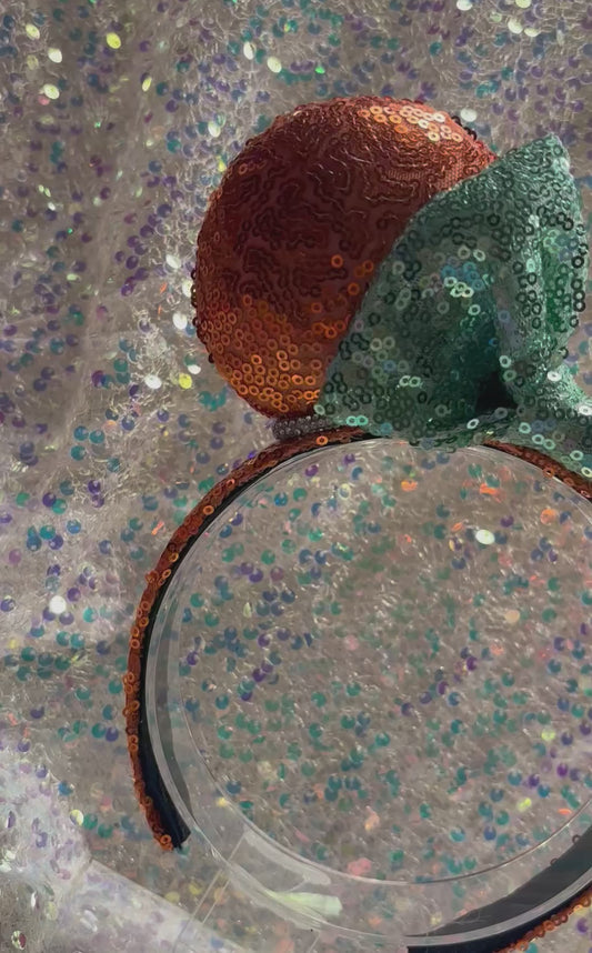 For the Showgirls! Orange Sequin Mouse ears with a mint green bow on a white glitter background