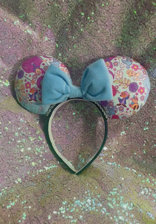 Cindy’s friend’s Mouse ears with a soft plush blue bow on a universal sized black poly cotton fabric headband. Handmade and ready to ship.