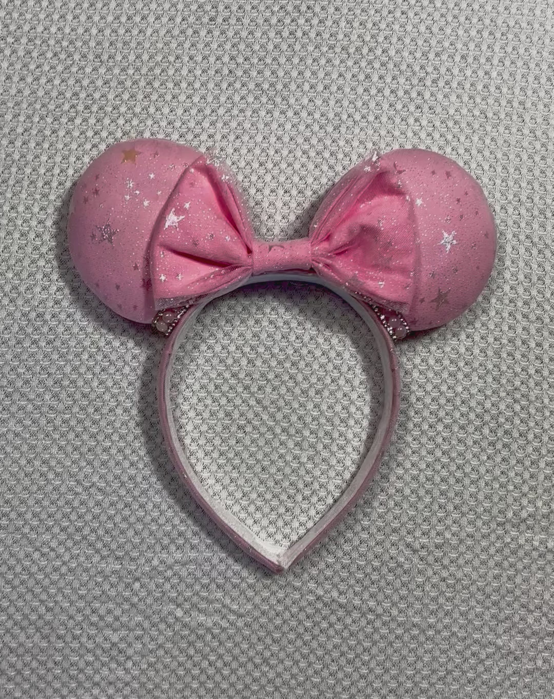 Handmade and ready to ship Pink Sparkling Iridescent fabric on pink to make mouse ears with the fabric on both the front and back along with the headband the is universal sized and fits most. The set has a matching bow, but you can request any sequin color in your order and I'll attach it. Item is shown on a white background.