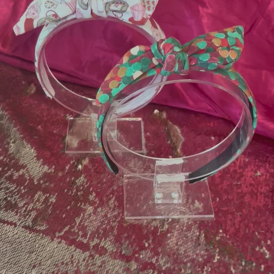 Two Handmade and ready to ship twisted bow headbands with designs in Christmas dots and Stocking Stuffers. Fabric is a soft and stretchy cotton Lycra fabric on universal sized headbands. 