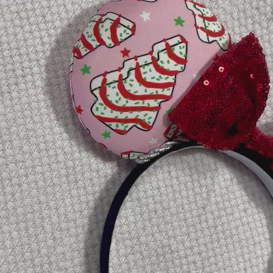 Handmade and ready to ship. Christmas cake fabric is on the ears front and back with a silver twisted trim. the bow is a red sequin one and the headband is a black poly cotton band that is universal.