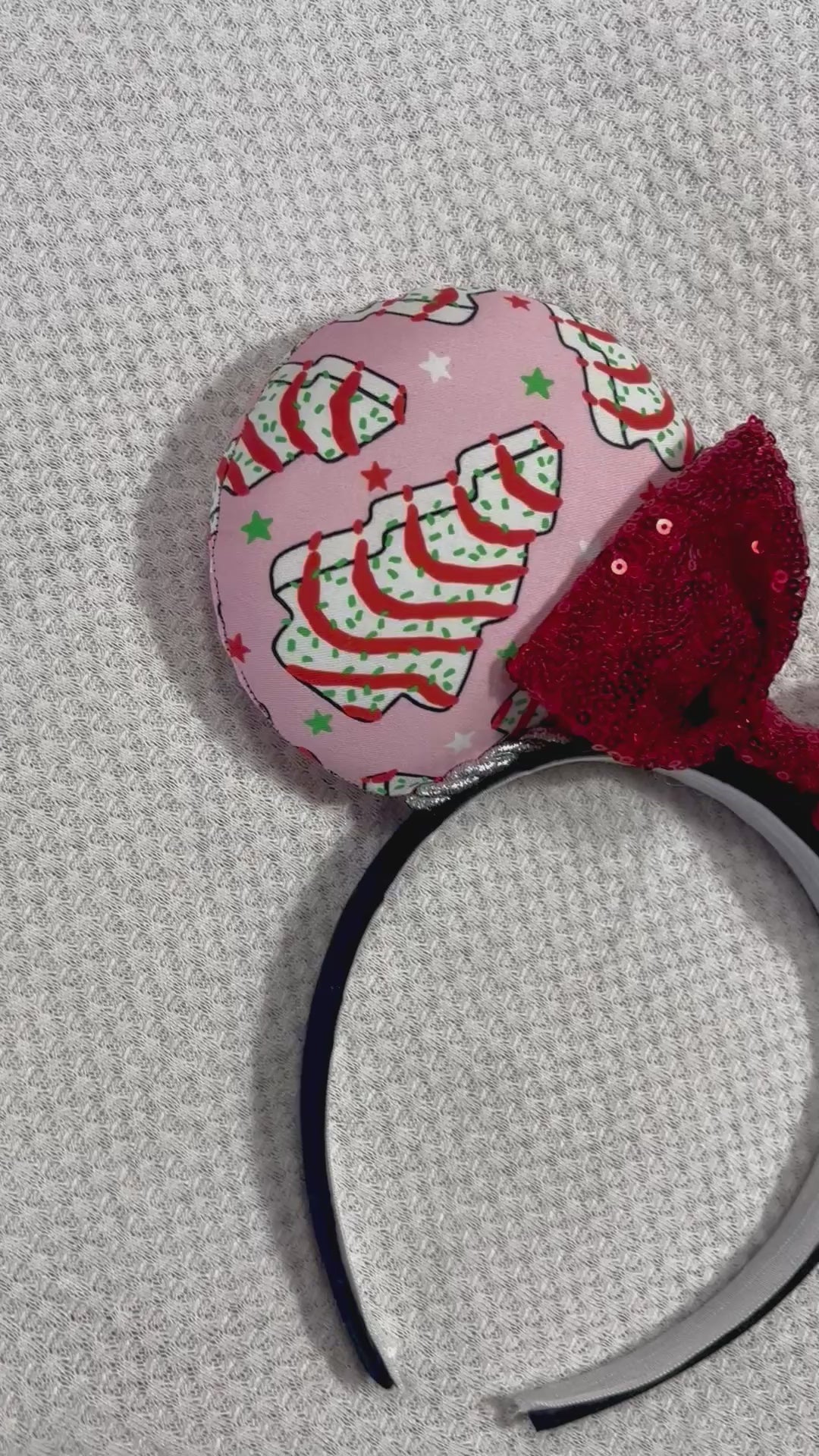 Handmade and ready to ship. Christmas cake fabric is on the ears front and back with a silver twisted trim. the bow is a red sequin one and the headband is a black poly cotton band that is universal.