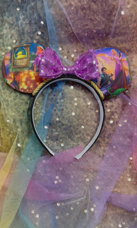 Decorative headband with colorful design and glittery accents on a textured background
