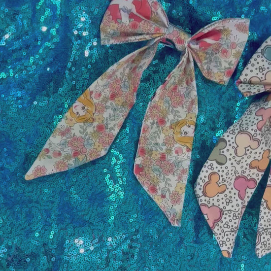 Handmade and ready to ship. Two French tailed hairbows come in this bundle in: Pretty Princess and Mouse Balloon fabric. French barrette backings are on the bow's backs.