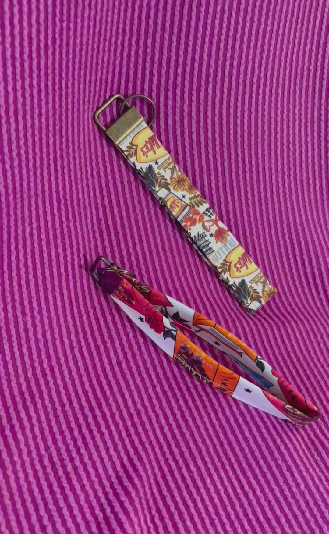Keychain with colorful design on a purple striped background