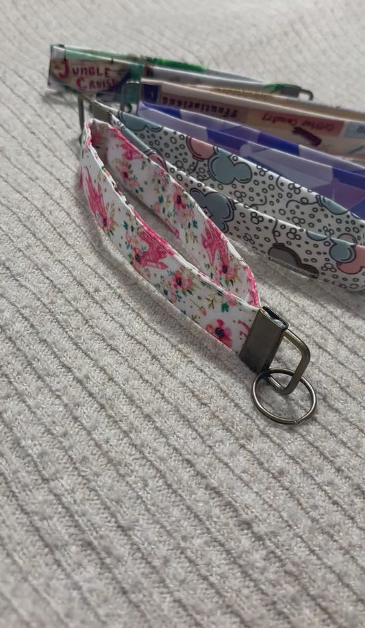 Five colorful keychain wristlets with different patterns inspired by Magic Kingdom. 