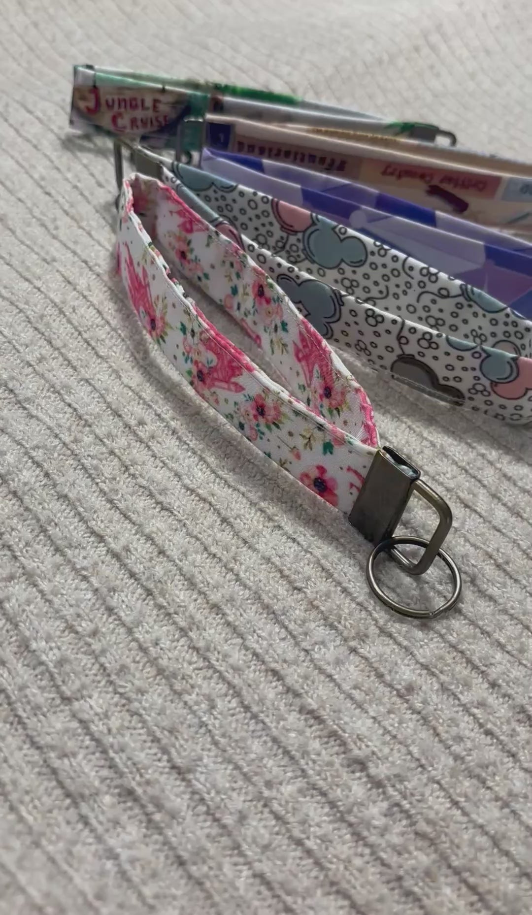 Five colorful keychain wristlets with different patterns inspired by Magic Kingdom. 