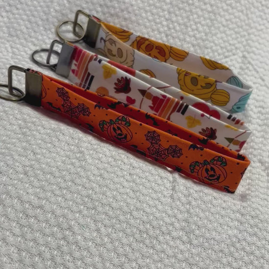 Handmade and ready to ship. Three keychain wristlets with Halloween-themed designs in: Mouse pumpkin, boo to you and thanksgiving fabric designs. 