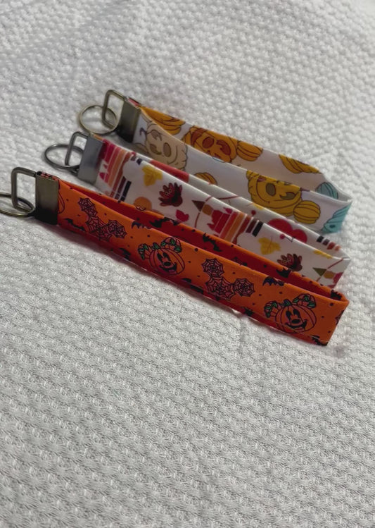 Handmade and ready to ship. Three keychain wristlets with Halloween-themed designs in: Mouse pumpkin, boo to you and thanksgiving fabric designs. 