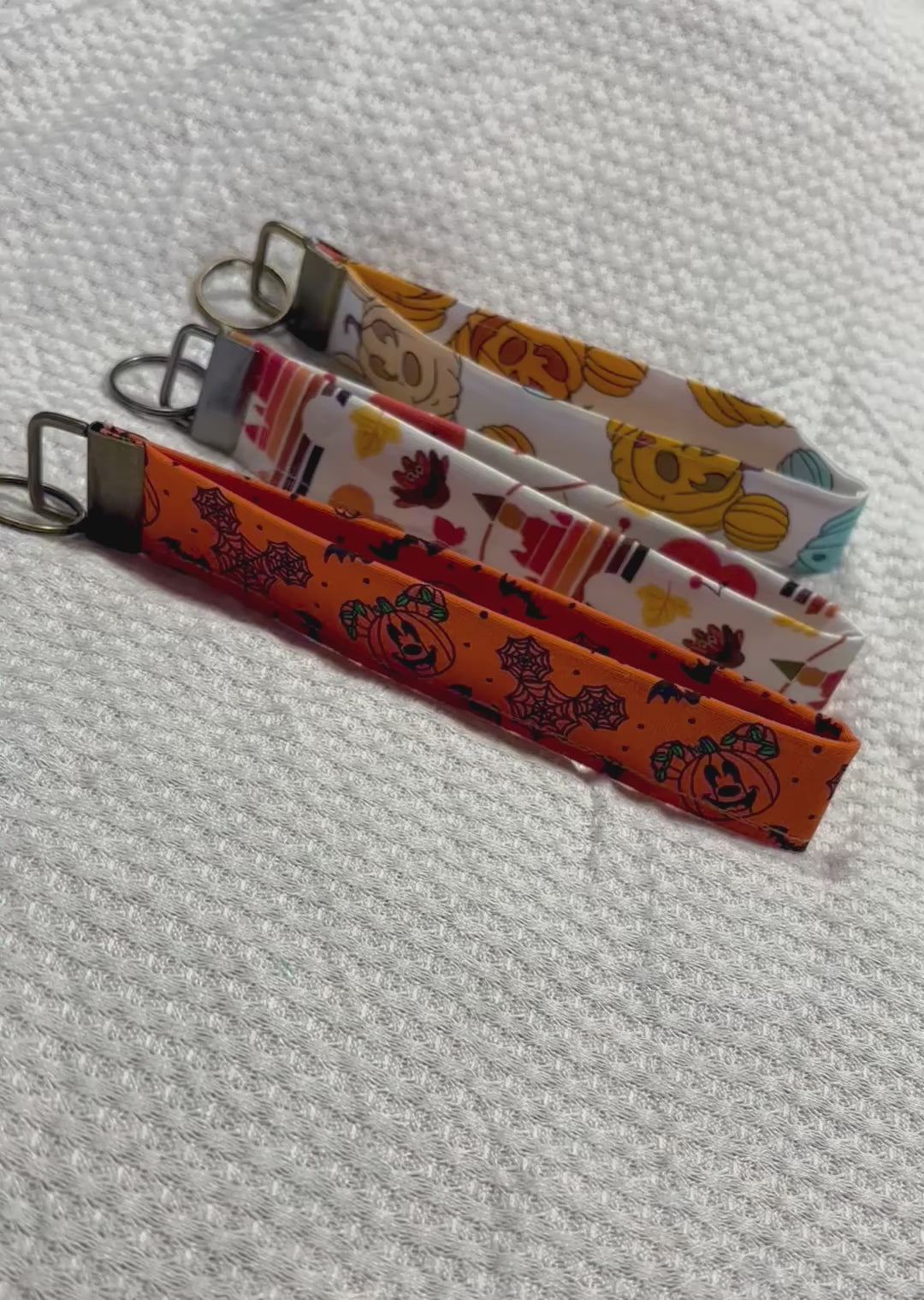 Handmade and ready to ship. Three keychain wristlets with Halloween-themed designs in: Mouse pumpkin, boo to you and thanksgiving fabric designs. 