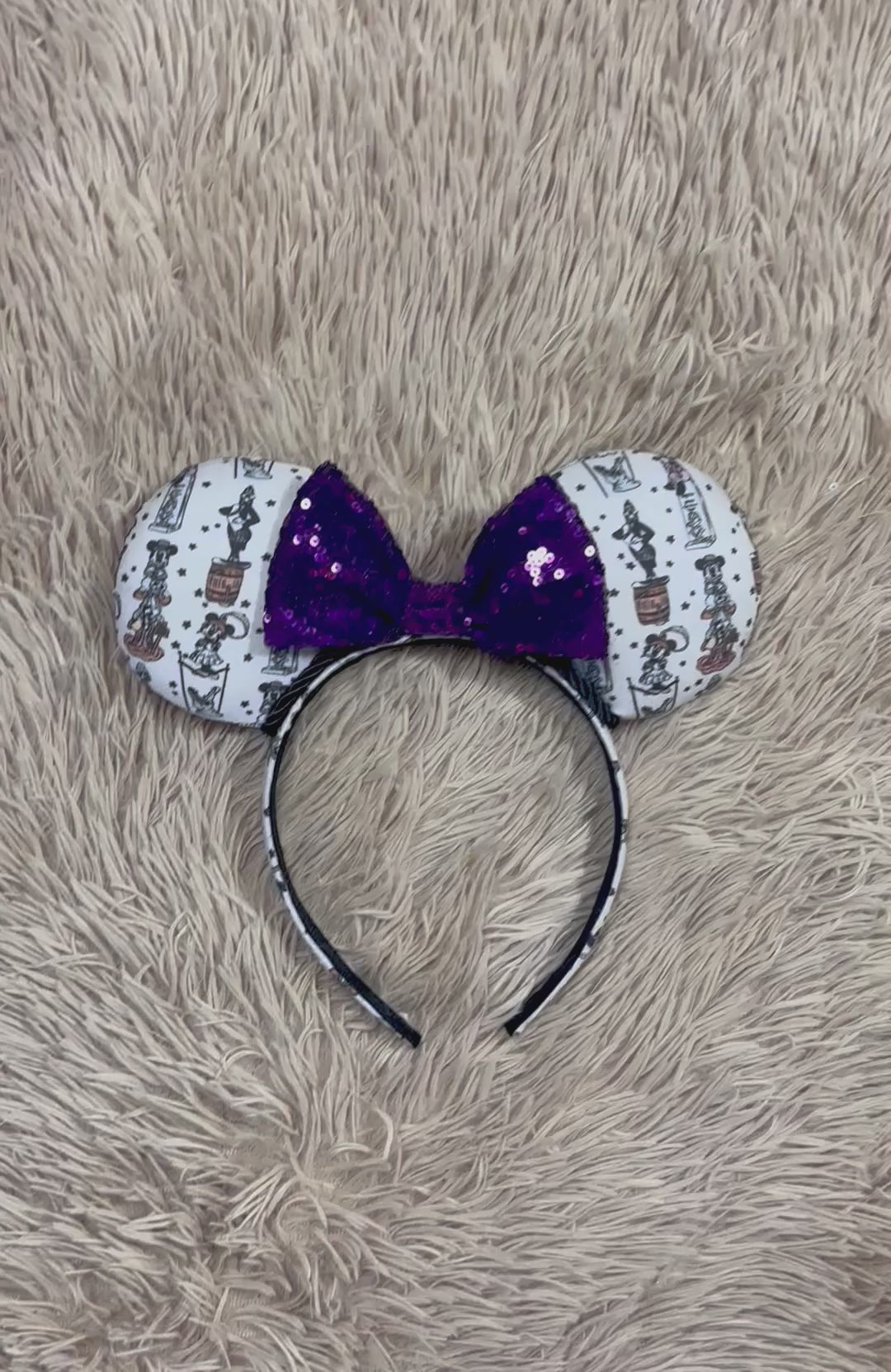 A set of ears with a fab 5 stretching room fabric on the ears front and back along with the headband as well. Black twisted trim along the inner ears with a purple sequin bow. 