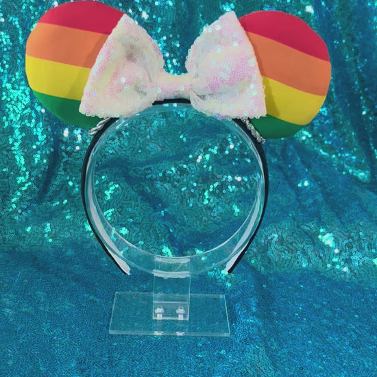Handmade and ready to ship Pride Mouse ears with a white iridescent sequin bow with silver twisted trim and on a black universal sized headband.
