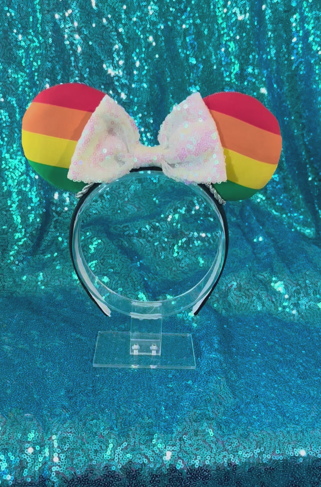 Handmade and ready to ship Pride Mouse ears with a white iridescent sequin bow with silver twisted trim and on a black universal sized headband.
