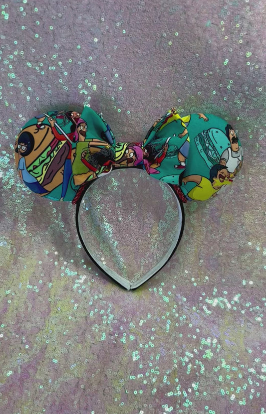 Handmade and ready to ship Burger Boss Mouse ears with the fabric on the ears, front and back and the bow. The headband is a universal sized headband and has black poly cotton fabric on it.