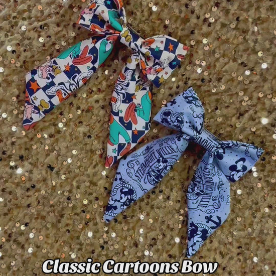 Two handmade and ready to ship French Tailer hairbows with Barrette backings on them. One bow is Pretty Goofy and the other is Steamboat. 