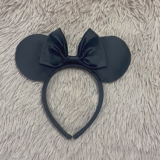 Black velvet mouse ear headband with a large matching velvet bow on a velvet universal sized headband.