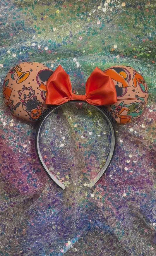 Handmade and ready to ship Cat Lover Mouse ears with an orange satin bow with black twisted trim and on a black universal sized headband.