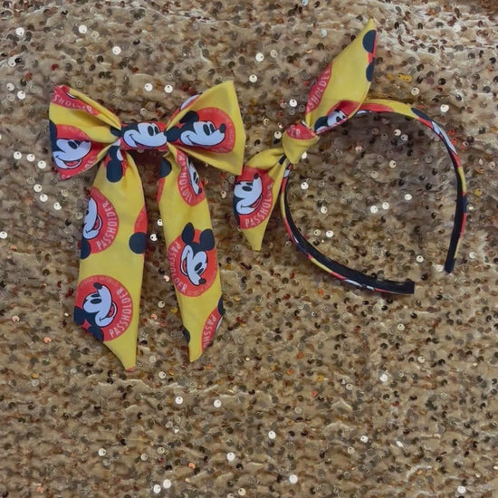 Handmade and ready to ship hair bow and twisted bow headband with cartoon character design with AP logo.