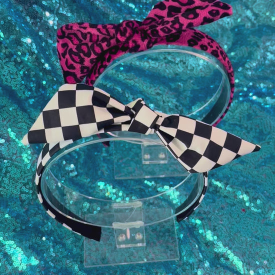 Two handmade and ready to ship headbands with twisted bow adjustable tops on a universal sized headband with elastic lining.